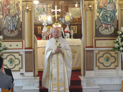 Fr Dimitri in front of the iconostasis