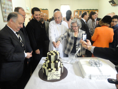 Fr Dimitri and Kh Nawal cutting the cake